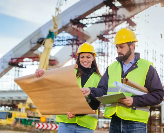 Two civil engineers review plans for a commercial project that required Drone Surveys in Champaign IL